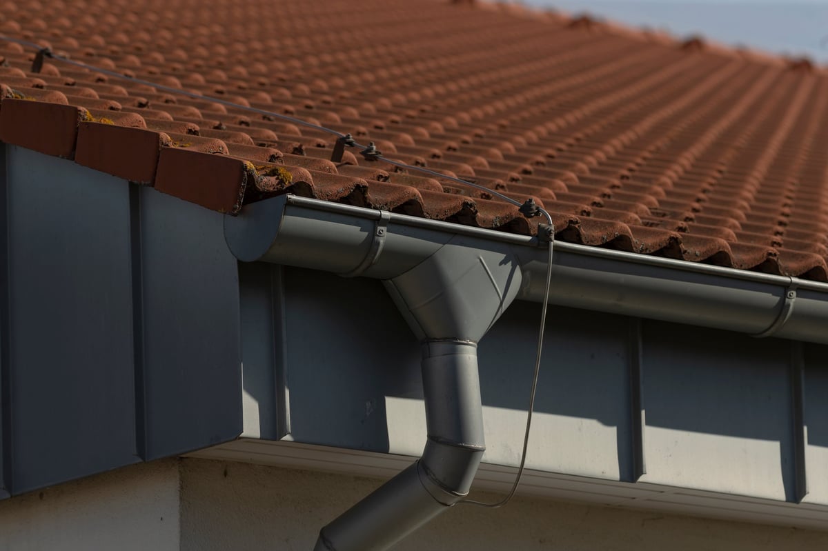 Closeup of a rain gutter installed on a residential house roof
