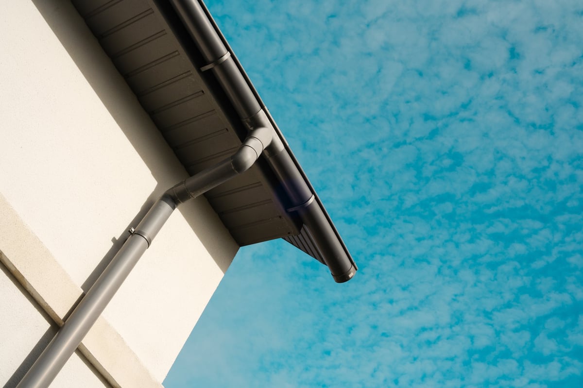 Clean gutter and roofline on a contemporary home against a bright blue sky