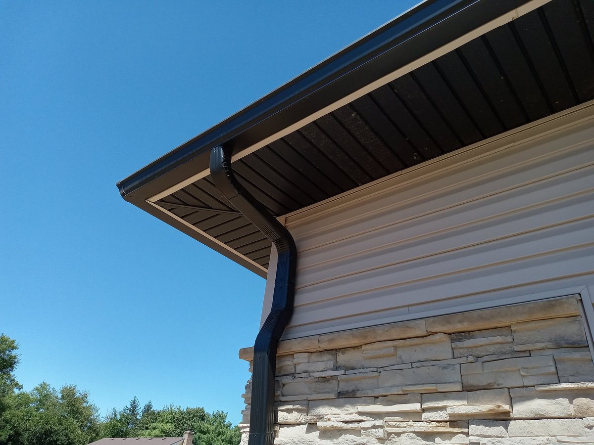 Clean residential gutters and roofline after a professional replacement