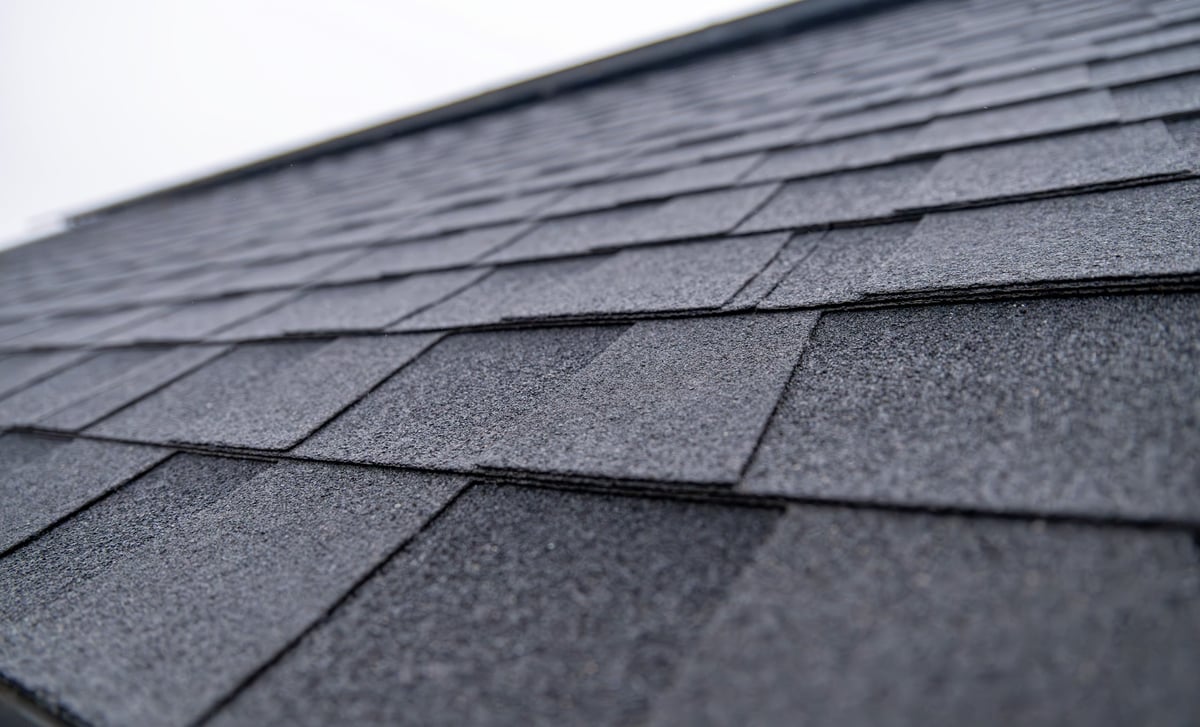 Close-up of dark gray residential asphalt roof shingles